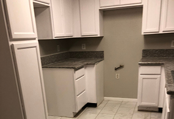 San Fernando kitchen remodel featuring white cabinetry and granite countertops.